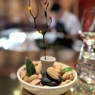 a bowl of nuts and a branch