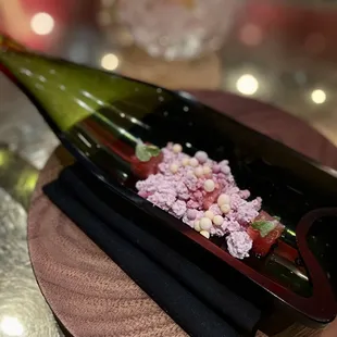 a bottle of wine with flowers in it