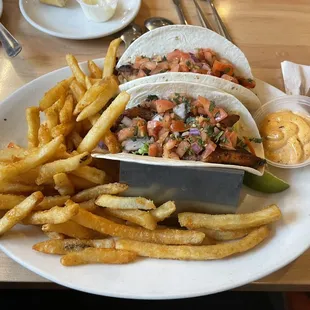Blackened Fish Tacos with spicy ranch and crispy fries.
