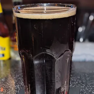  a glass of dark beer
