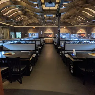 Inside. Dining room. There are three conveyor belts, each surrounded on either side by five booths. Some booths seat four, others six.