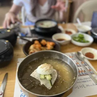 a woman sitting at a table with food