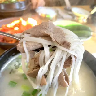 a bowl of soup with meat and noodles