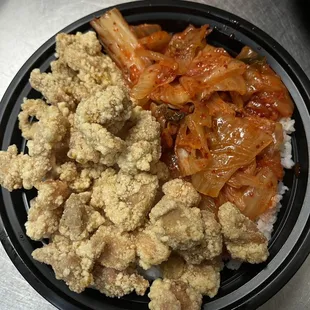 a bowl of rice, meat, and vegetables