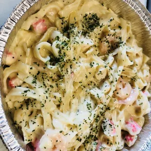 a bowl of pasta with shrimp and cheese