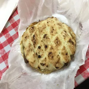 a flat bread on a checkered tablecloth