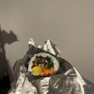 a piece of food wrapped in foil