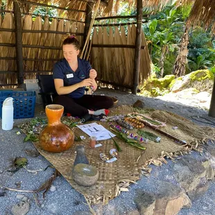 Demonstrating how to make a flower lei