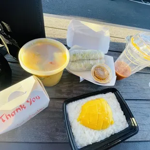 a tray of rice with a mango and a cup of coffee