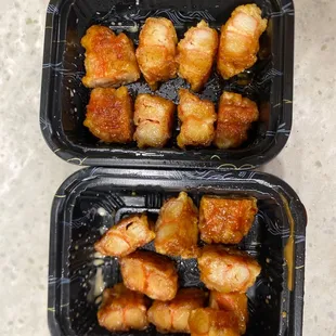 two takeout containers of chicken wings