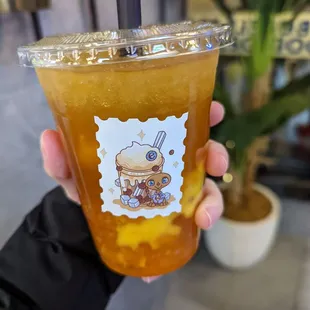 a person holding a cup of iced tea