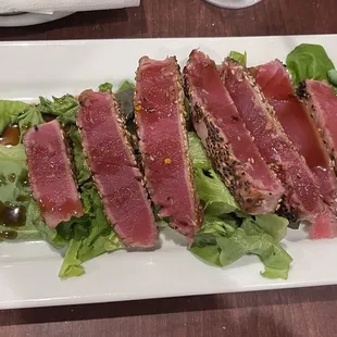 Sesame encrusted ahi tuna with lettuce and wasabi.