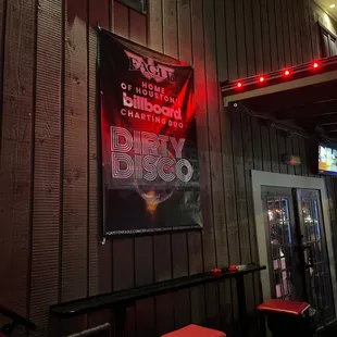 red stools in front of a sign