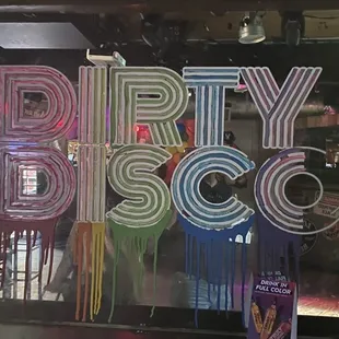 a dirty disco sign in a bar