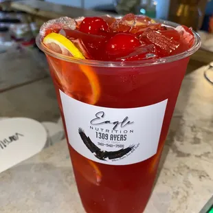 a cup of iced tea with cherries