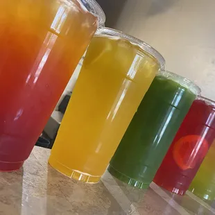 a variety of juices lined up on a counter