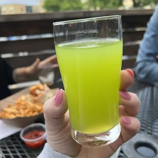 a person holding a glass of beer