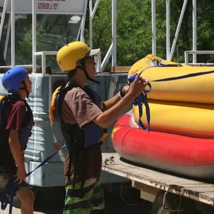 BSA Merit Badge.  Scouts here are securing the kayaks with tie downs and using the boaters knot for lock down.