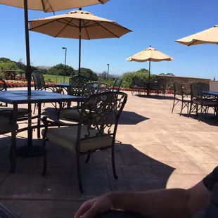 a patio with tables and umbrellas