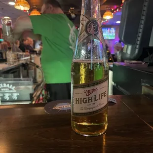 a bottle of beer sitting on a bar