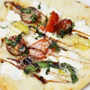 Naan Flat Bread with mozzarella, parmesan and options with romano, tomato, basil, ricotta, garlic, italian parsley, pepperoni, &amp; salami