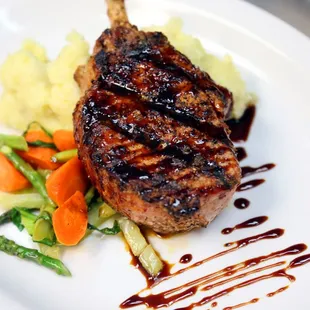 10 oz. Lollipop Porkchop with sweet molasses glaze, cheddar mash or baked potato, &amp; mixed vegetables