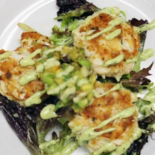 Jumbo Lump Crab Cakes. Three cakes with avocado salad &amp; cilantro pesto aioli