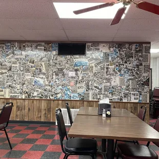 a dining area with a large wall of comics