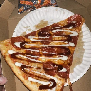 a slice of pizza on a paper plate