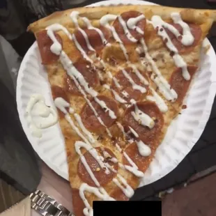 a slice of pizza on a paper plate