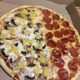 a pizza with pineapples and mushrooms