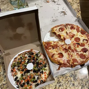 Gluten free crust veggie pizza and a large pan pizza with pineapple and pepperoni.