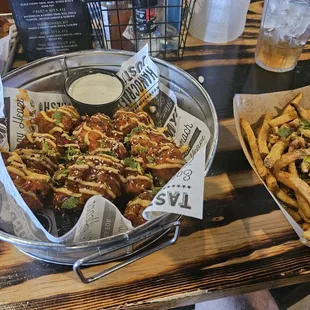 Chicken wings. With spicy Tai sauce and French fries, with pops seasoning.