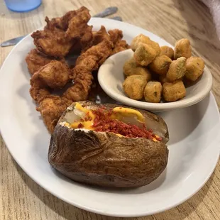 Chicken strips, loaded baked potato and okra.
