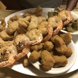 Shrimp and fried fish with corn fritters and beans as sides