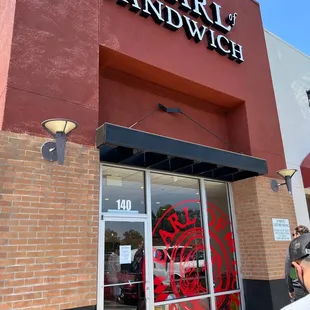 the entrance to a sandwich shop
