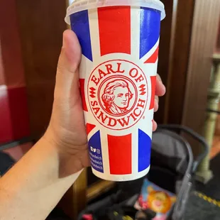 a hand holding a cup of coffee