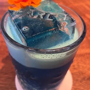 This drink is blue, beautiful, and foamy! Love the contrast of the color and flower. AND THE ICE!!