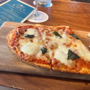 a slice of pizza on a cutting board