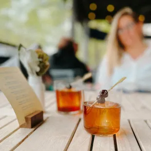 two glasses of tea on a wooden table