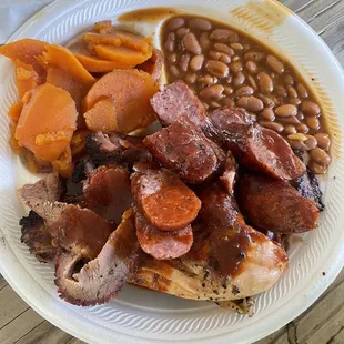 a plate of meat, beans, and carrots