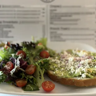 Avocado toast with fresh salad.