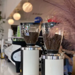 two coffee grinders on a counter