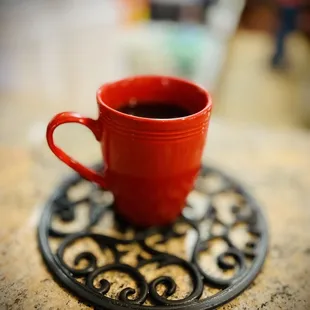 a cup of coffee on a placemat