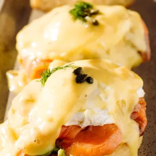 two eggs benedicts with salmon and cheese