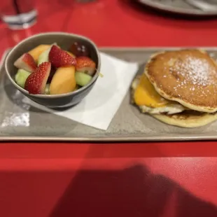 pancake sammy with sausage and a fruit cup