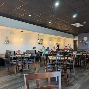 people sitting at tables in a restaurant