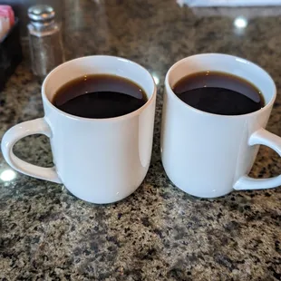 two cups of coffee on a counter