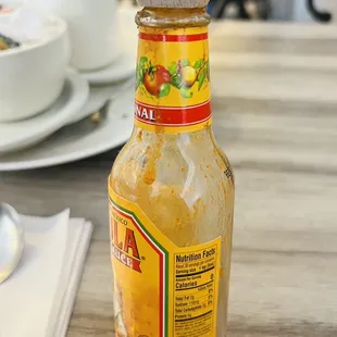 Dirty hot sauce bottle. They do not care to clean the bottle after each guest.