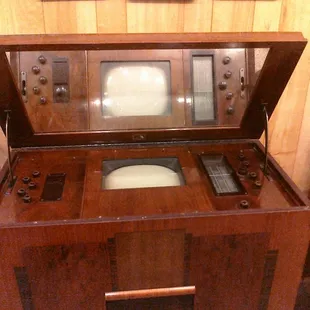 The picture tubes were so long, they had to be mounted upright, hence the mirror.